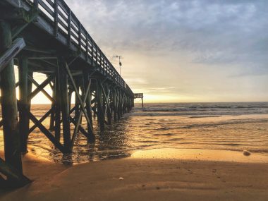 Sunrise over the horizon at the Isle of Palms Pier in South Caroline