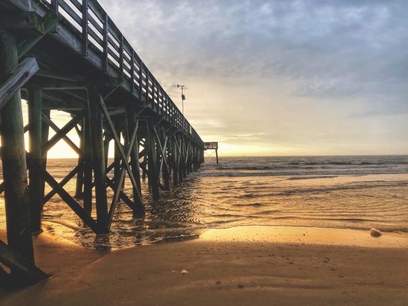 Sunrise over the horizon at the Isle of Palms Pier in South Caroline