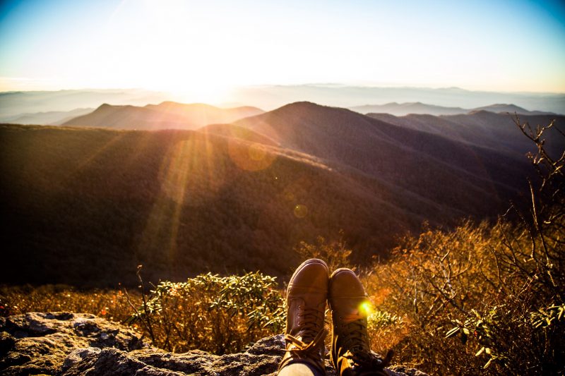 Photographer's boots and the mountains during sunset in North Carolina.