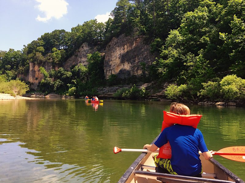 A young boy canoes for his first time down the Buffalo National River in Harrison, Arkansas.