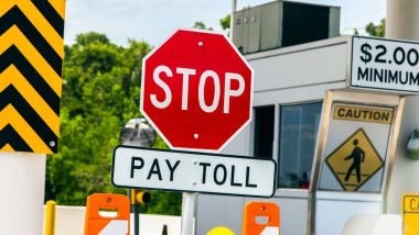 A large stop sign indicating the toll for the road needs to be paid before proceeding.