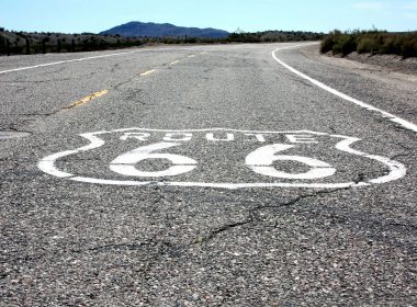 A shield shape with Route 66 painted in white along the US highway.