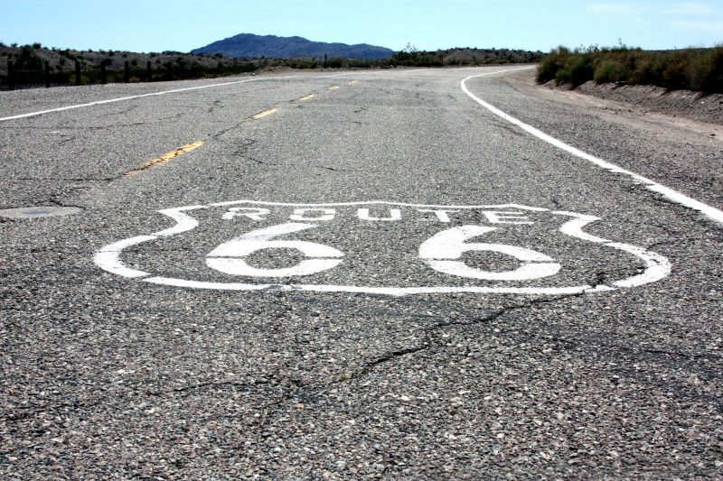A shield shape with Route 66 painted in white along the US highway.