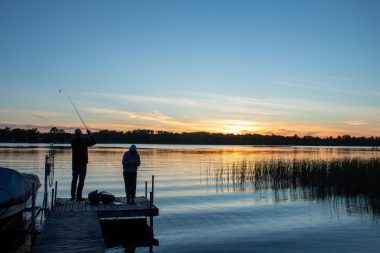 Fishing at sunset from a dock at the lake