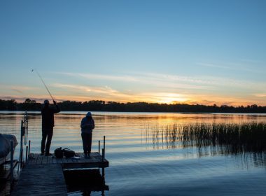 Fishing at sunset from a dock at the lake