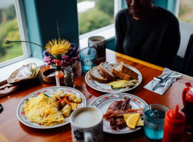 Two diners enjoying omelettes for breakfast while traveling.