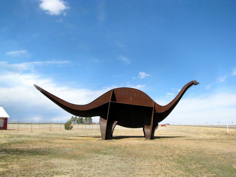 A life-size dinosaur sculpture in the shape of an Apatosaurus named Cimmy sits outside of the Cimarron Heritage Center in Boise City, OK.