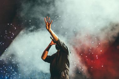 Lead singer performing at a live outdoor concert venue