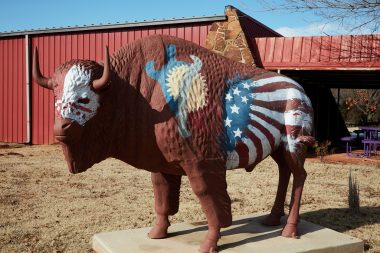 A decorated buffalo (or American bison) sculpture on the grounds of the National Hall of Fame for Famous American Indians in Anadarko, a small city in southwest Oklahoma that includes the headquarters of the Apache Tribe of Oklahoma.