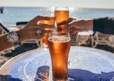 People toasting with beer on the beach