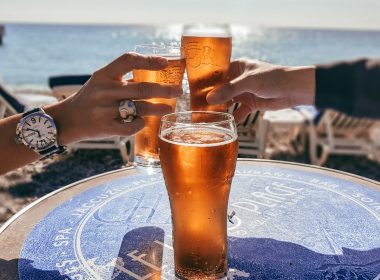 People toasting with beer on the beach