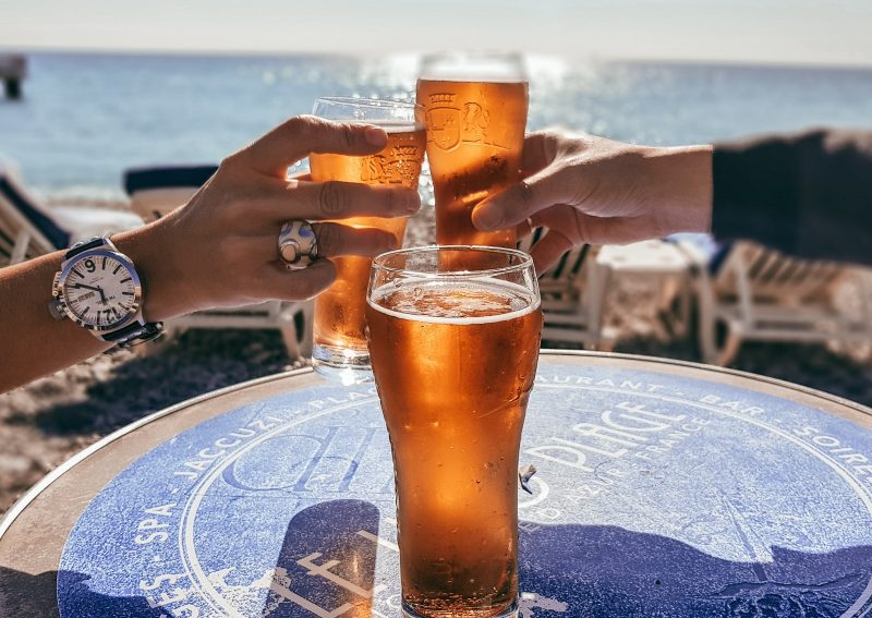 People toasting with beer on the beach