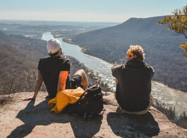 Two friends sit on a rock overlooking the Tennessee River