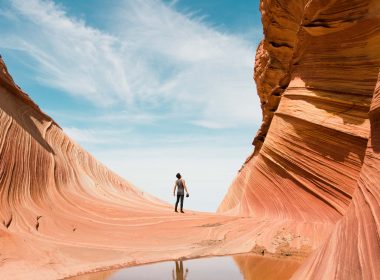 A man look up in awe at the rock formations along the Wave Trail in Kanab, Utah.