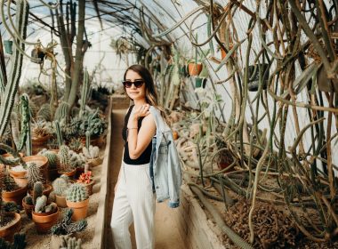 A woman in a cactus green house in a botannical garden in California