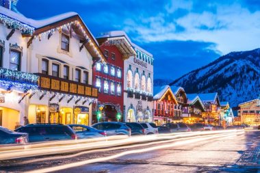 A street with Bavarian buildings lit up with lights in the winter in Leavenworth, Washington.