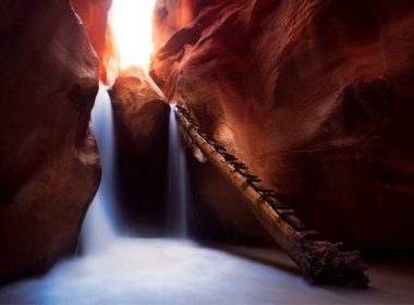Kanarraville Falls pours into a canyon made of red rock in Utah.