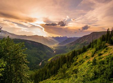 Sunset over a valley in Glacier National Park from high up in the mountains on Going-To-The-Sun Road.