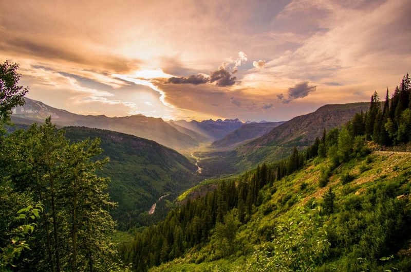 Sunset over a valley in Glacier National Park from high up in the mountains on Going-To-The-Sun Road.