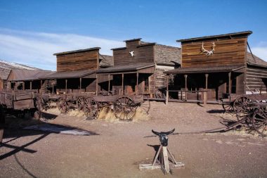Antlers and skulls mounted on the outside of wooden tavern buildings in Cody, Wyoming.