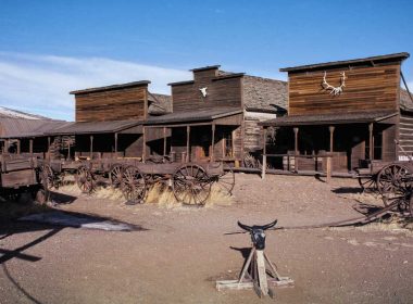 Antlers and skulls mounted on the outside of wooden tavern buildings in Cody, Wyoming.
