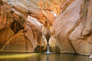 A waterfall rolls down a canyon into Guffey Gorge