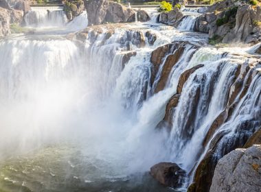 Sun shining through mist churned up by the Shoshone Falls in Idaho.