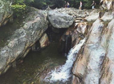 A group of friends walk above the lower Bolten Pothole in the Green Mountain National Forest.