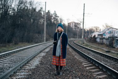 Woman hiking in the winter along of train rail line in New Hampshire