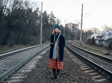 Woman hiking in the winter along of train rail line in New Hampshire