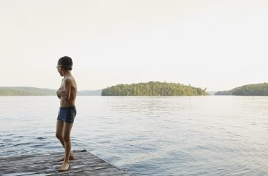 Boy playing at lake along Lake Ontario
