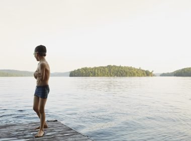 Boy playing at lake along Lake Ontario