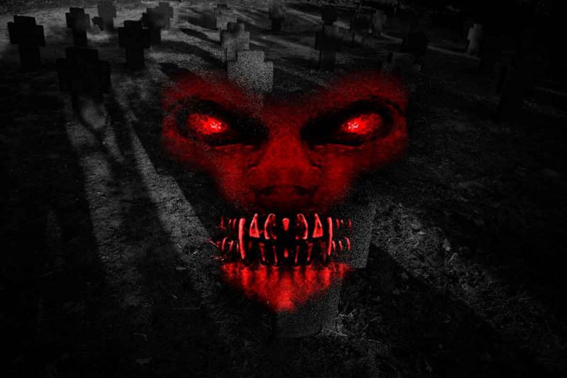 A portrait of an evil monster with red eyes and fangs overlayed on a dark cemetery photograph.