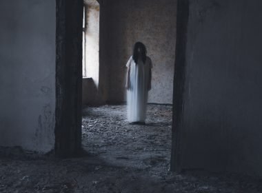 Female ghost walking through a room in The Conjuring house