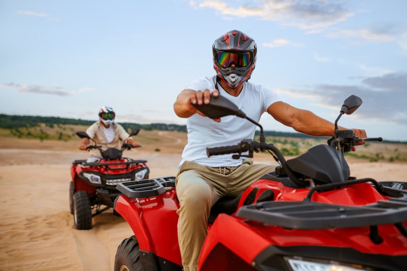 Two men driving ATVs at Mines and Meadows