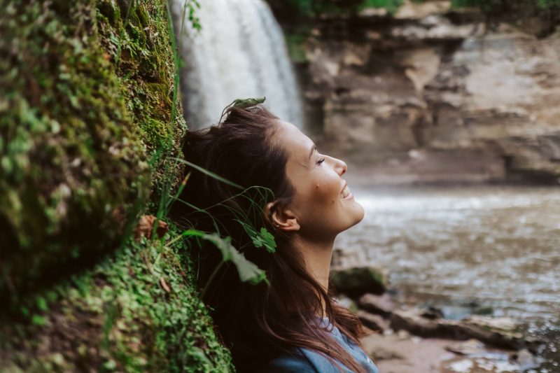 Woman standing beside Glen Ellis Falls