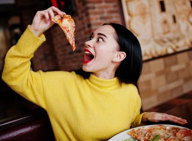 Woman eating pizza in Old Forge, PA