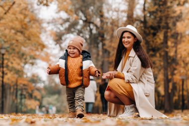 Mom and son walking through Alapocas Run State Park in the autumn