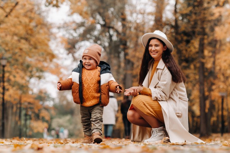 Mom and son walking through Alapocas Run State Park in the autumn