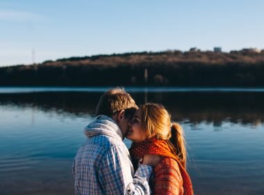 Couple kissing in front of lake in Pennsylvania