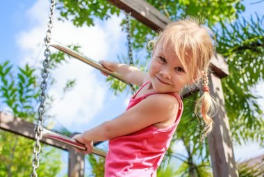 Girl climbing on play ground in Duke Island Park