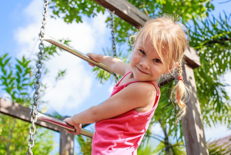 Girl climbing on play ground in Duke Island Park