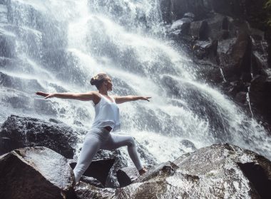 Woman doing yoga in front waterfall in New Hampshire