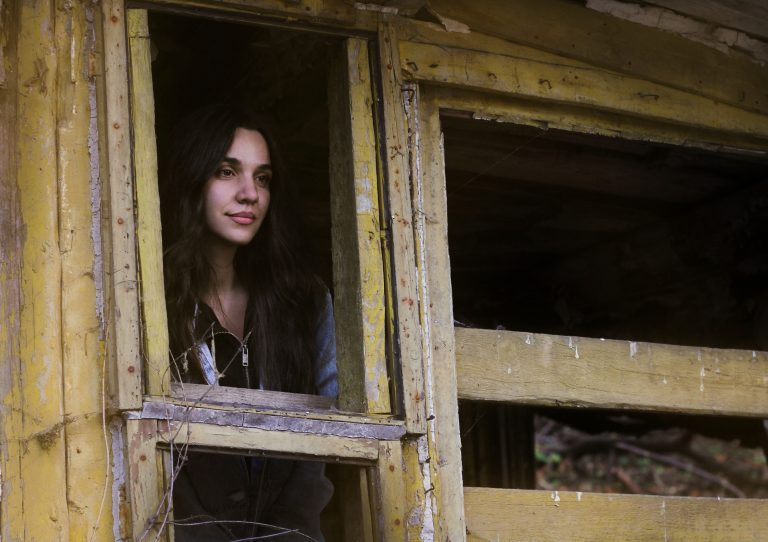Woman exploring abandoned Bell's Mansion